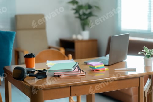 Preview: Cozy home office setup with laptop, notebooks, and coffee on wooden table