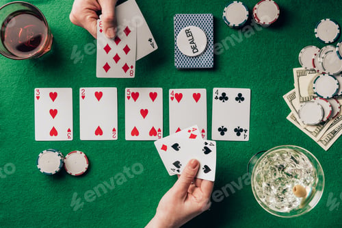 Preview: Men and woman playing poker by casino table with cards and chips