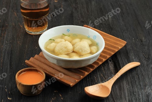 Preview: Soup With Dumplings And Orange Colored Sauce