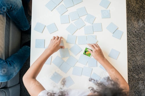 Preview: Girl playing memory game, overhead view