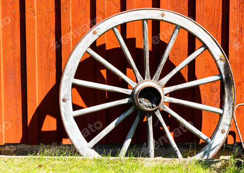 Preview: View of an old wagon wheel against the sunlight