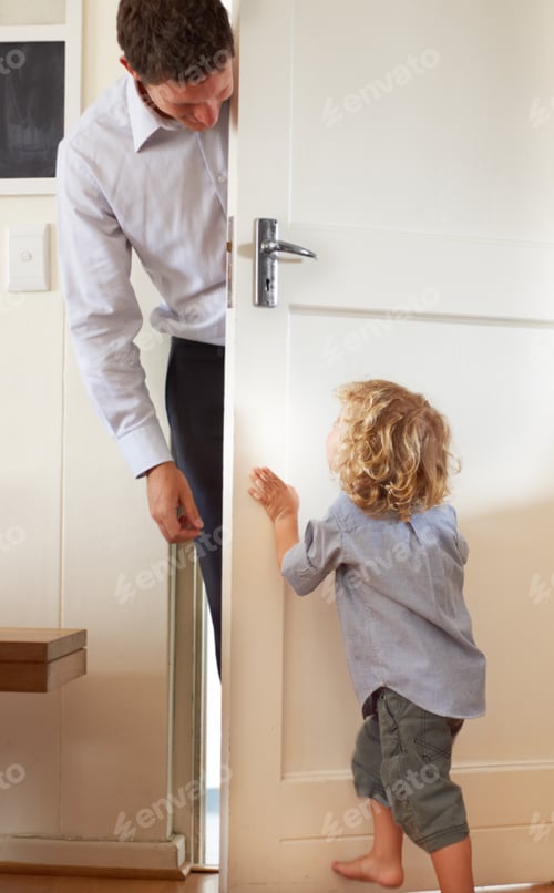 Preview: A little boy playfully push a door closed while his father stands on the other side