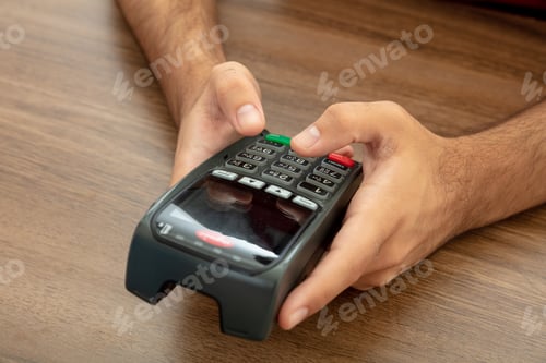 Preview: Man typing on a POS terminal, payment with credit card. Banking, shopping concept.