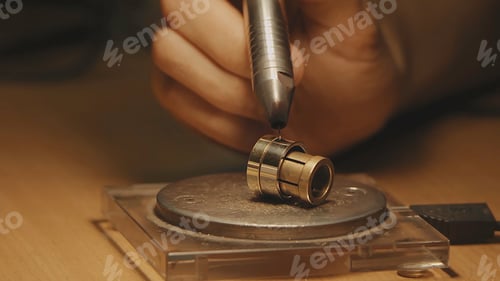 Preview: Production of rings. Jeweler working with wax model ring in his workshop. Craft jewelery making