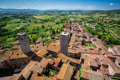 Preview: View of the red roofs and green valley in San Gimignano, Italy