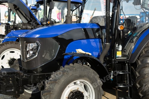 Preview: Bright Blue and Black Agricultural Tractor on Display