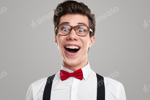 Preview: Funny happy nerd in glasses in studio