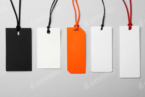 Preview: Different tags with space for text on light background, flat lay