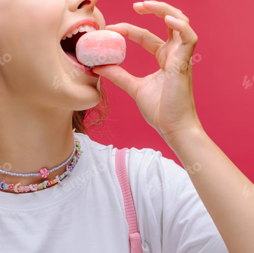 Preview: Young woman enjoys a colorful dessert against a vibrant pink background