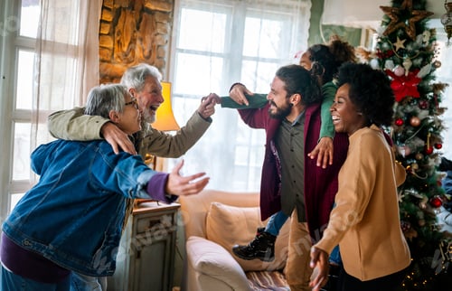 Preview: Happy multiethnic multi-generational family enjoying Christmas time together. People love concept.