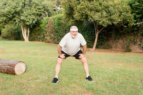 Preview: tired senior man resting after jogging