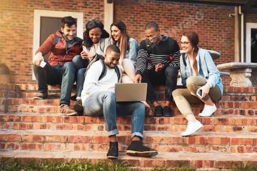 Preview: Shot of a group of students using a laptop together on campus