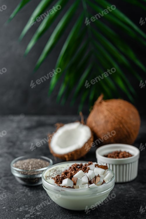 Preview: Coconut yogurt with granola and chia on dark background.