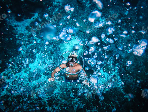 Preview: Man free diving and making rings