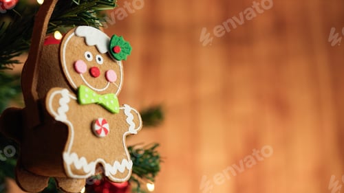 Preview: Gingerbread man decoration on a Christmas tree with falling snow