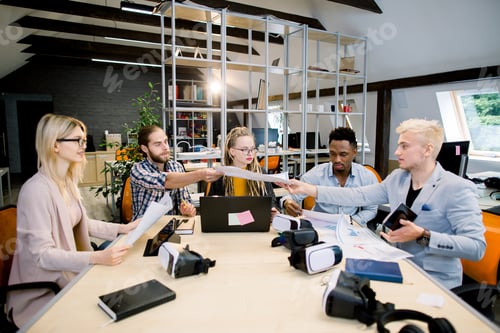 Preview: Team of casually dressed businesspeople discussing ideas in the office. Creative multiethnical