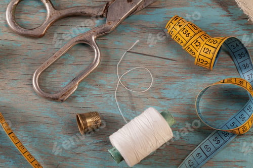 Preview: Retro sewing accessories on blue wooden background