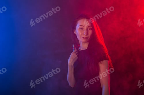 Preview: Portrait of asian young woman in red and blue neon smoke
