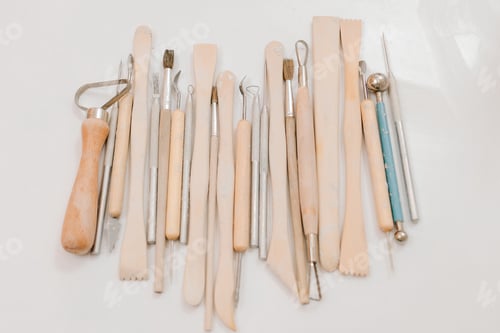 Preview: Pottery sculpting tools for ceramics. Tools laid out on workshop table