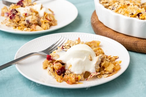 Preview: Apple and pear crumble with ice cream, streusel. Sweet dessert with stewed fruit topped