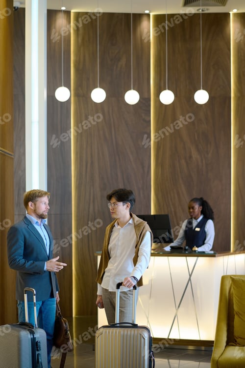 Preview: Two elegant businessmen with baggage discussing working points of travel