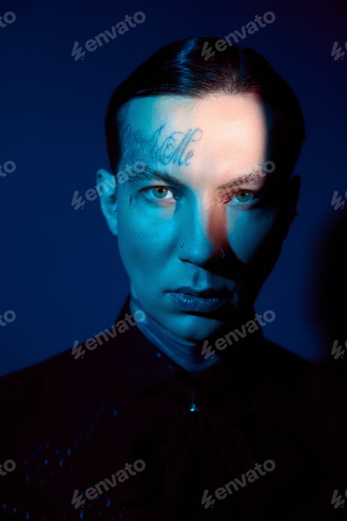 Preview: Handsome young man showcases unique style in striking blue lighting scene