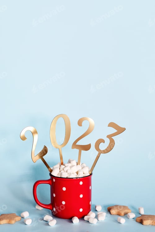 Preview: Christmas or New Year 2023 creative concept. Hot chocolate in red mug and golden numbers 2023