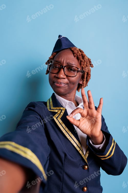 Preview: Female flight attendant showing finger approval gesture