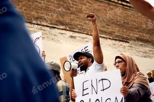 Preview: African American man shouting through megaphone on demonstrations against racism.