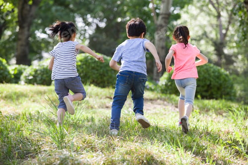 Preview: Happy children running in woods
