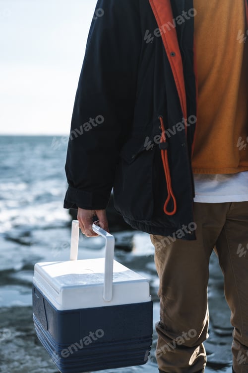 Preview: Fisherman wearing coat standing at the seashore