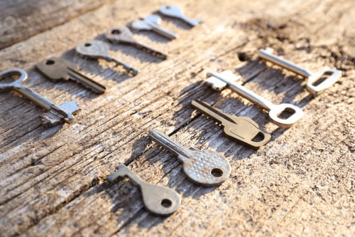 Preview: overhead of many different keys in oder on wooden background concept