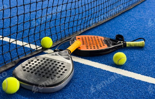 Preview: padel racket on a padel blue court with a ball
