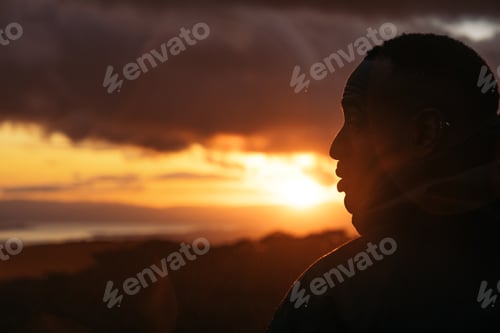 Preview: Man watching the sunset in nature
