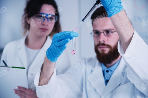 Preview: Young Male Researcher Holding Dropper And Test Tube