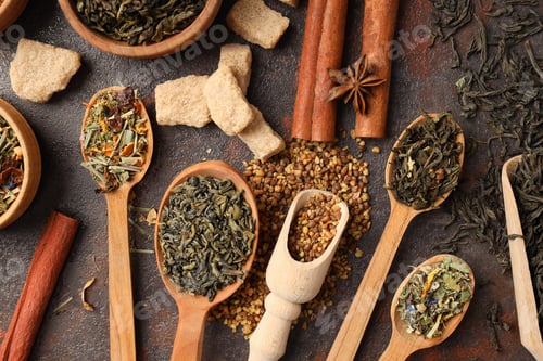 Preview: Concept of cooking tea with different types of tea on dark textured background