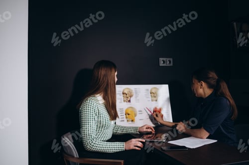 Preview: Consultation in cosmetology clinic. Female professional beauty doctor talking with pretty young
