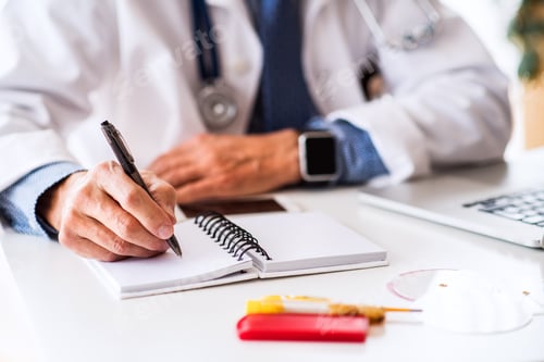 Preview: Senior doctor working at the office desk.