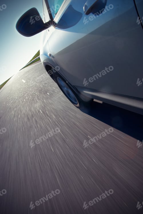Preview: Automobile moves at fast speed at sunrise