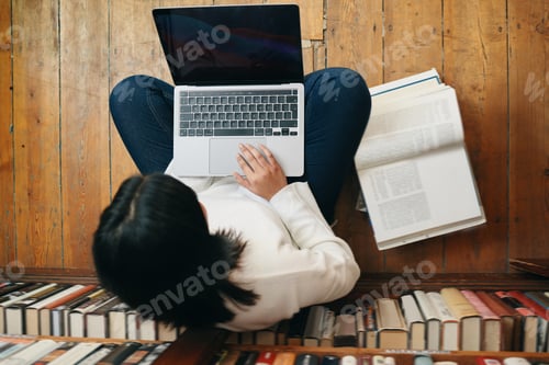 Preview: Shot of a female student working on her laptop in her school library