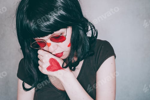 Preview: Cool portrait of a young woman wearing red glasses and full of red hearts