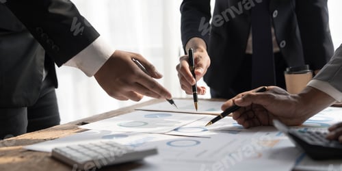 Preview: Business People Meeting using laptop computer,calculator,notebook,stock market chart paper for