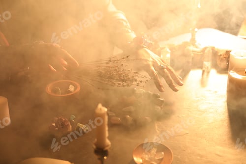 Preview: Woman doing ritual with healing stones at dark table, closeup