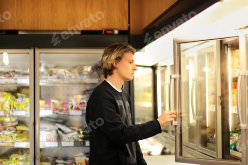 Preview: Man Shopping In Supermarket, Reading Product Information