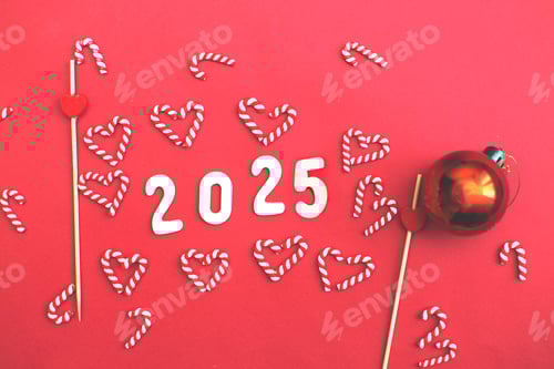 Preview: number 2025 on Christmas red background with candy canes and toy ball