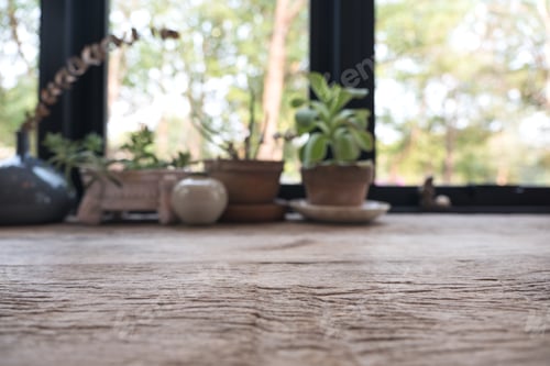 Preview: Closeup blur image of a wooden table with flowerpots in background