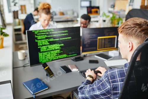 Preview: IT specialist writing codes on computer