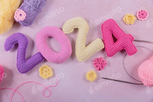 Preview: New Years background with multicolored crochet numbers 2024