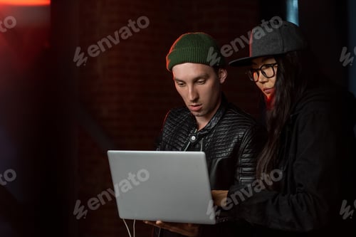 Preview: Two young hackers with laptop decoding information