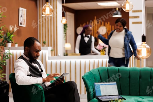 Preview: Hotel manager with digital device